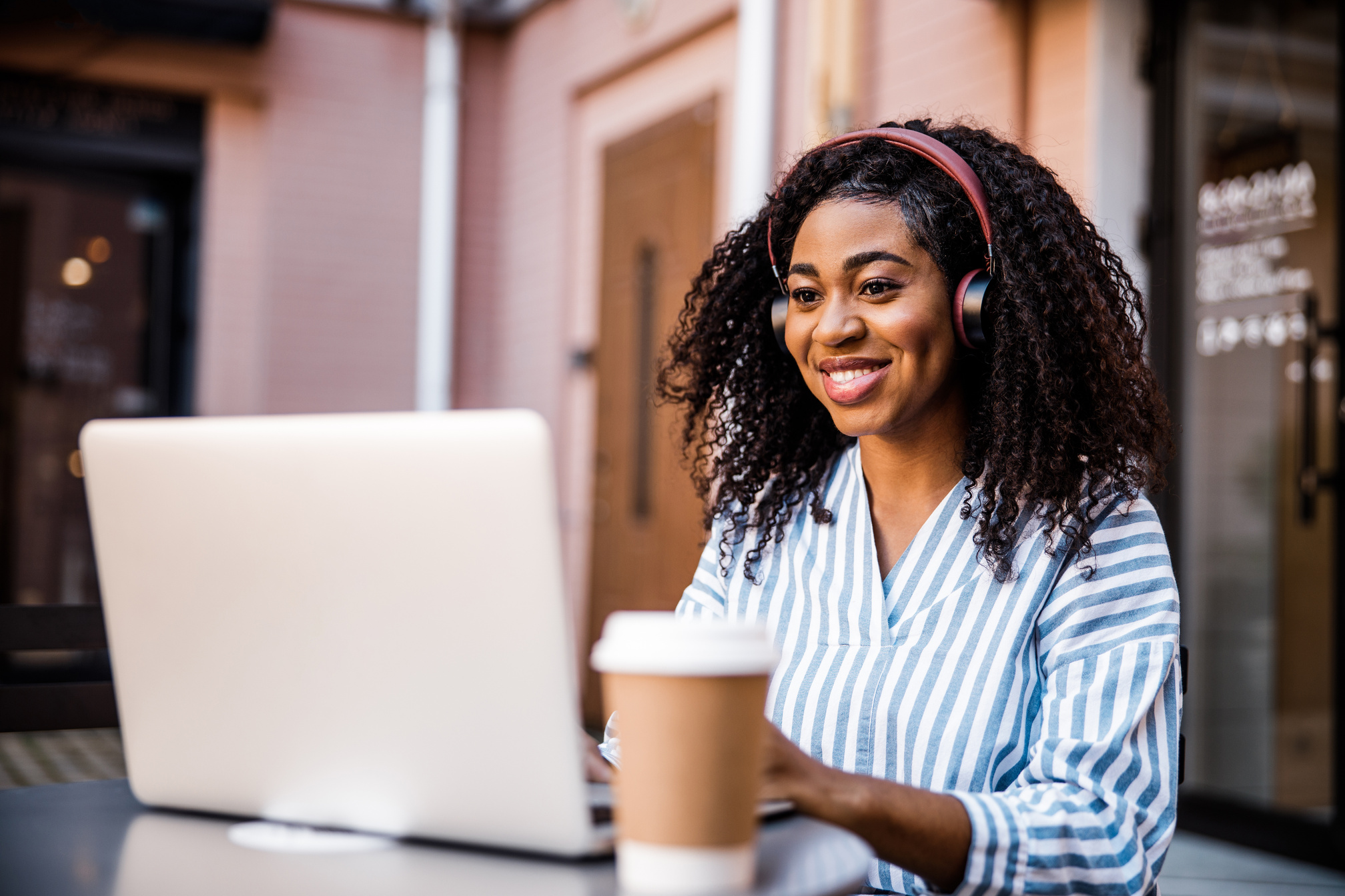 African lady is working at laptop computer